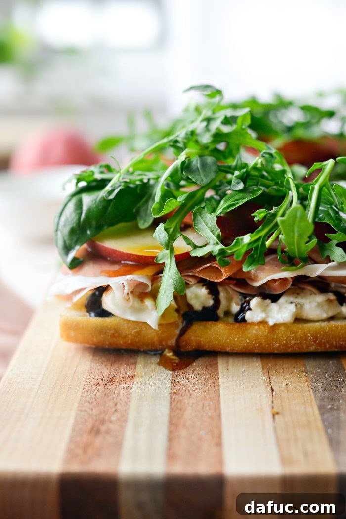 Finishing the sandwich with fresh basil and arugula