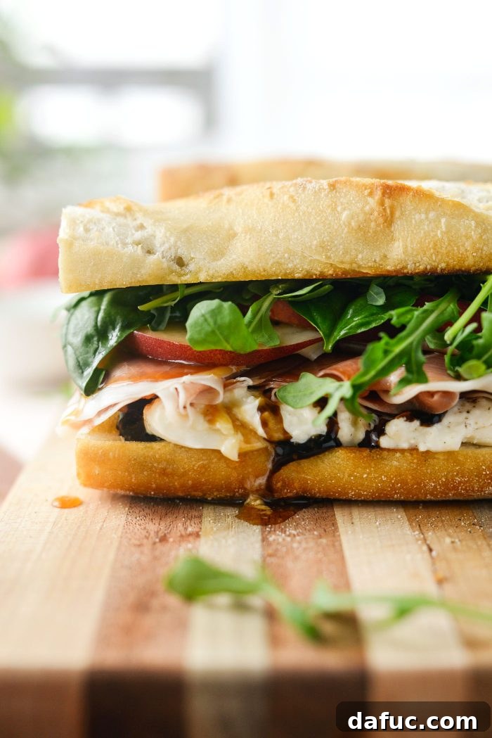 Fully assembled Peach Prosciutto and Burrata Sandwich, ready to be sliced