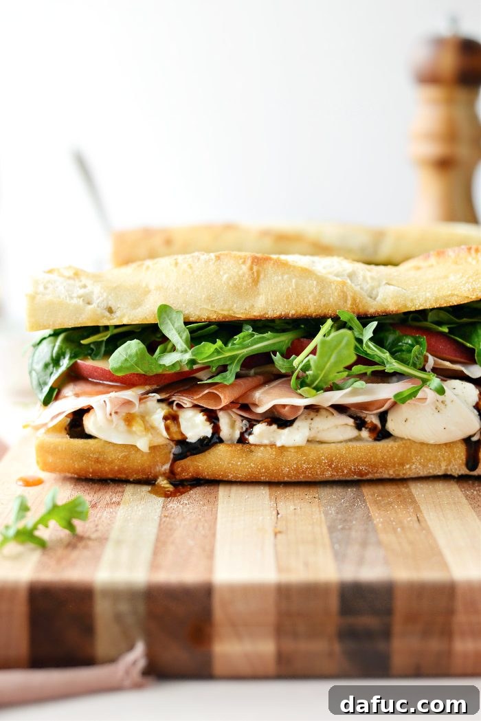 Two halves of the Peach Prosciutto and Burrata Sandwich presented beautifully