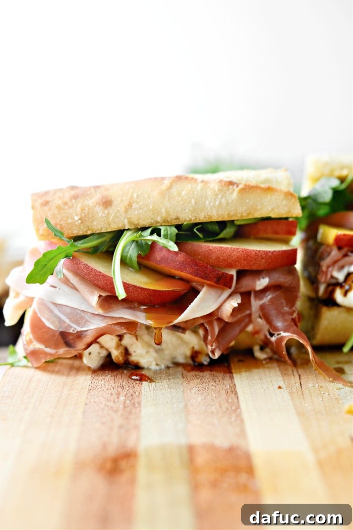 A vibrant Peach Prosciutto and Burrata Sandwich with fresh fruit, ready to be enjoyed