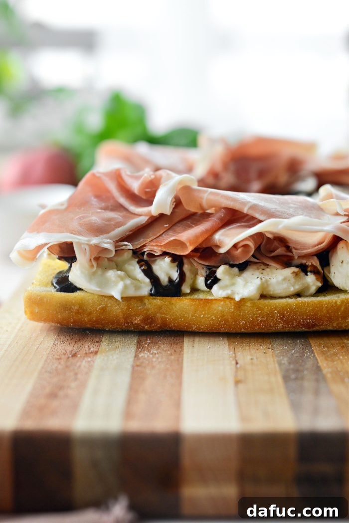 Seasoning burrata with black pepper, balsamic glaze, and prosciutto