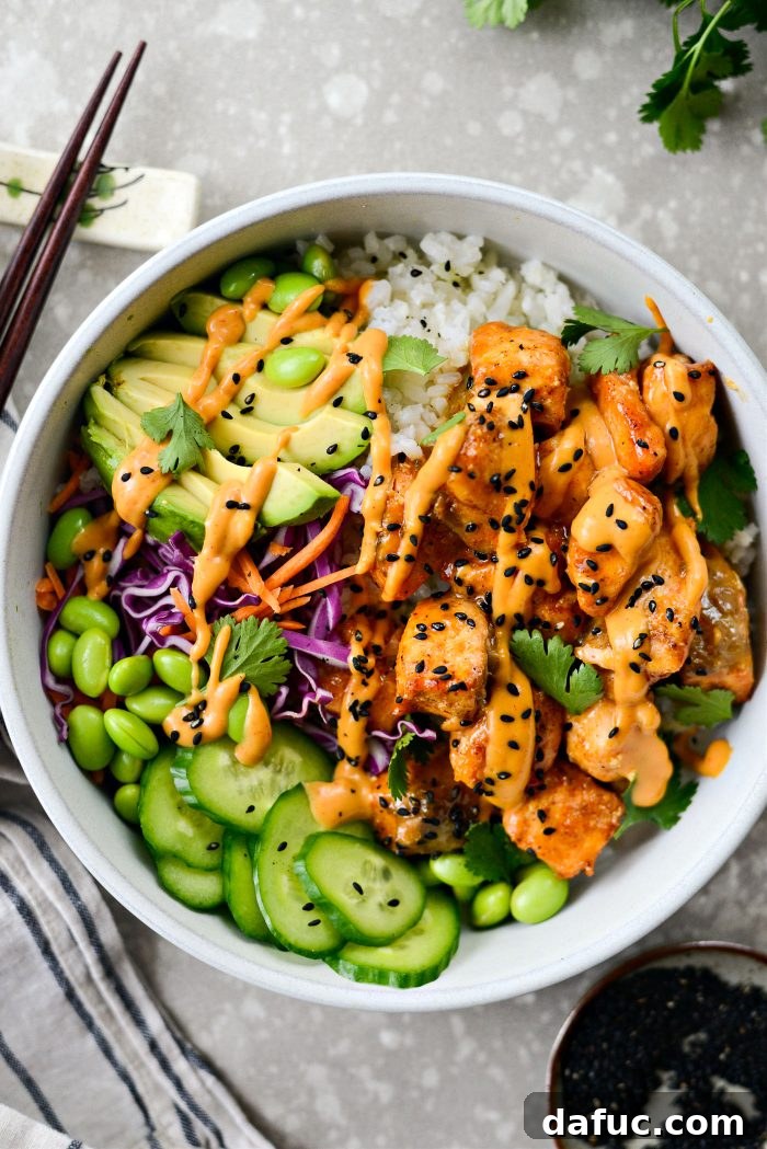 Dynamite Salmon Rice Bowls 2 Bang Bang Salmon Bowls featuring crispy salmon and fresh vegetables