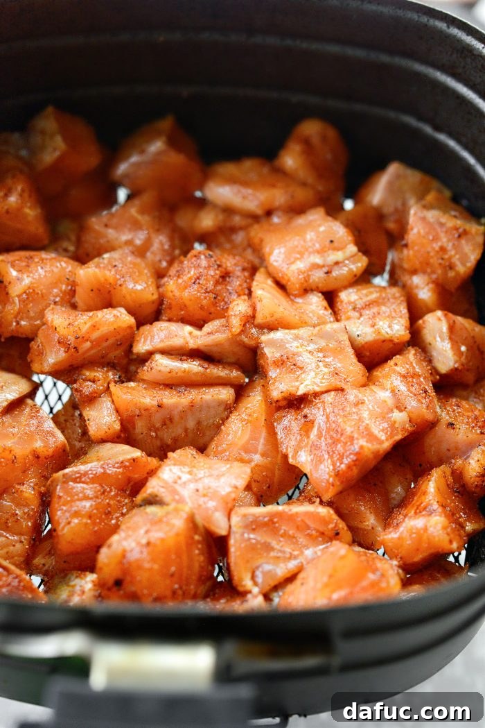 Dynamite Salmon Rice Bowls 11 Adding cooked salmon to the Bang Bang sauce bowl