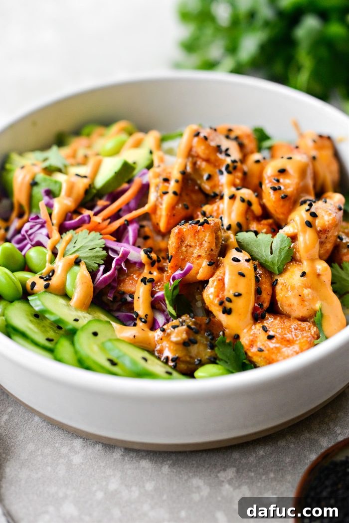 Dynamite Salmon Rice Bowls 3 Two Bang Bang Salmon Bowls ready to be enjoyed, showcasing the colorful ingredients