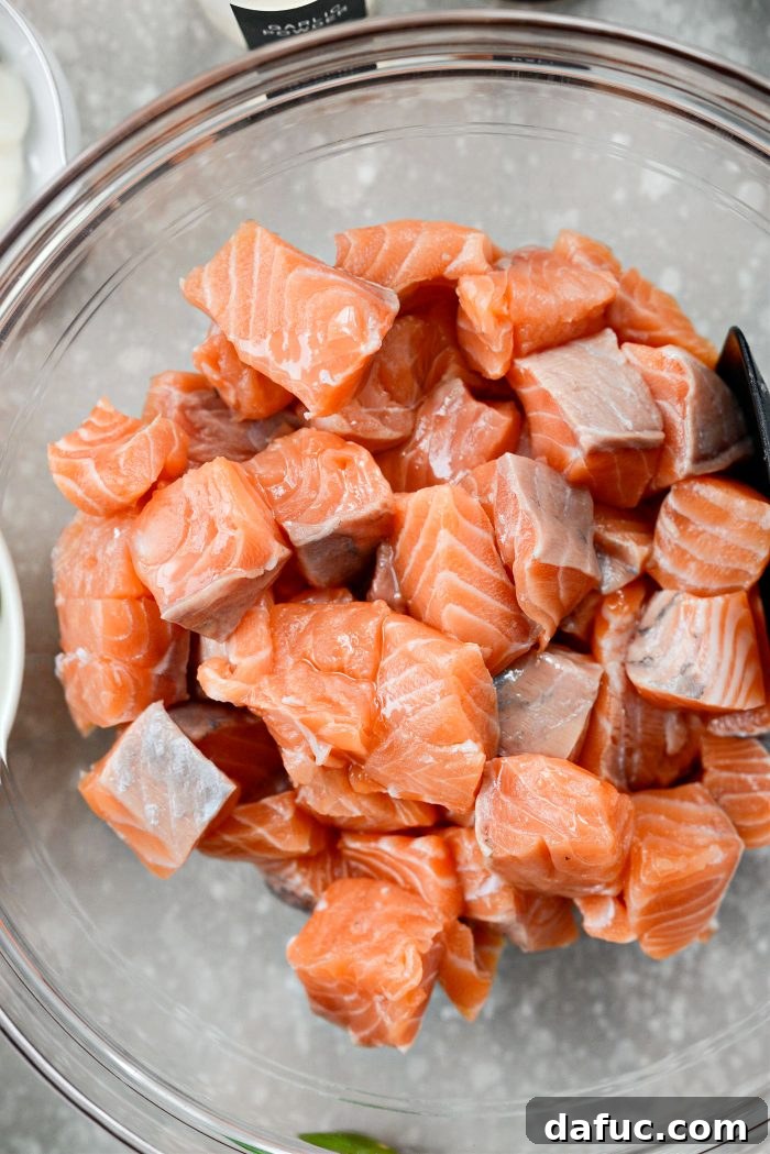 Dynamite Salmon Rice Bowls 7 Cubed salmon pieces drizzled with oil in a bowl