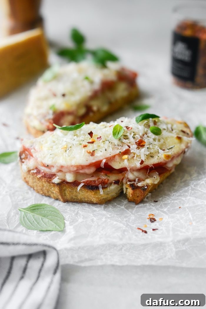 Margherita Toast Pizzas 12 Close-up of Margherita Pizza Toast, showing melted cheese and fresh basil