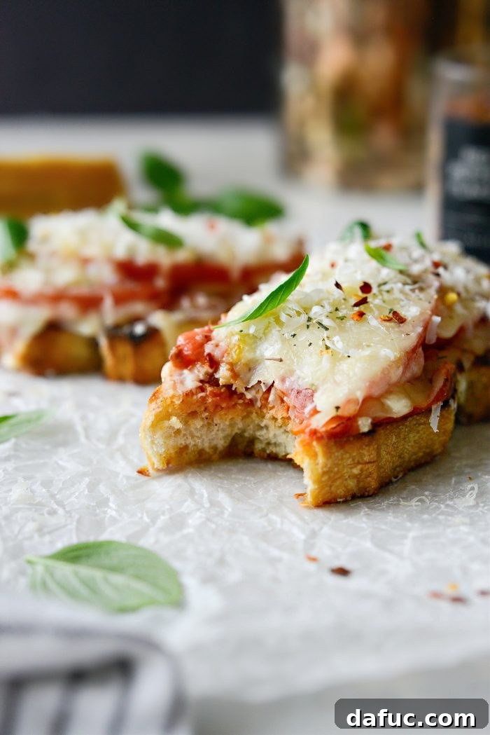 Margherita Toast Pizzas 3 Two slices of Margherita Pizza Toast with a side salad