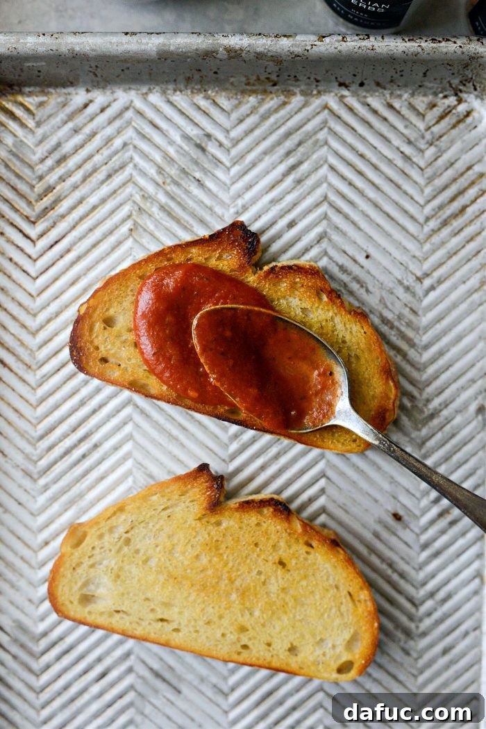 Margherita Toast Pizzas 6 Spreading pizza sauce on toasted sourdough bread