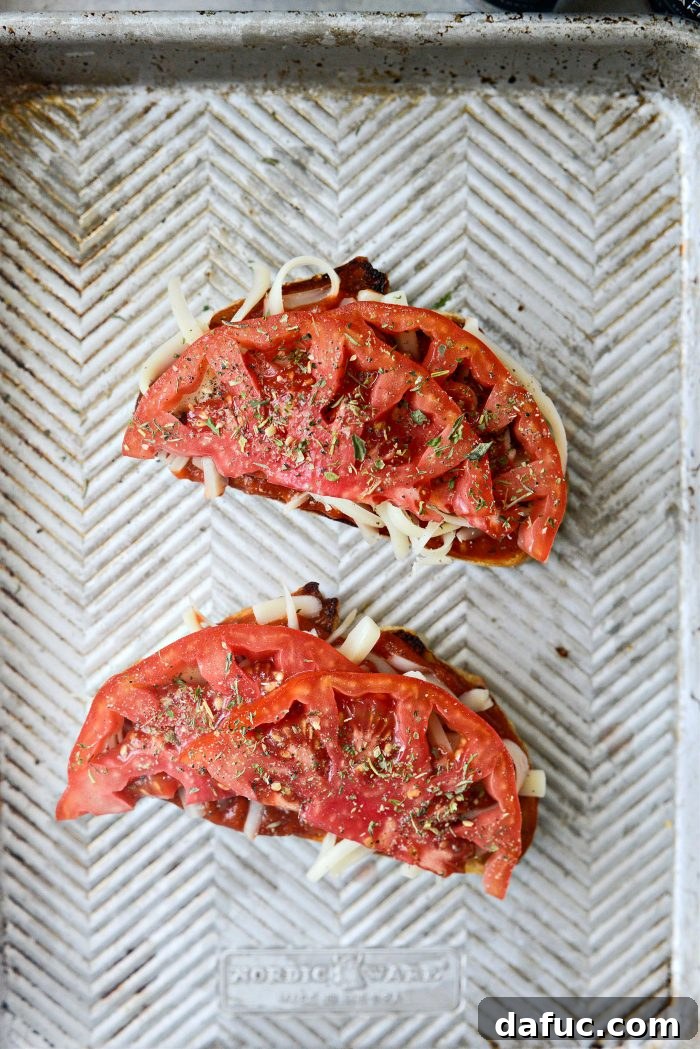Margherita Toast Pizzas 8 Topping pizza toast with sliced tomato, black pepper, and Italian seasoning