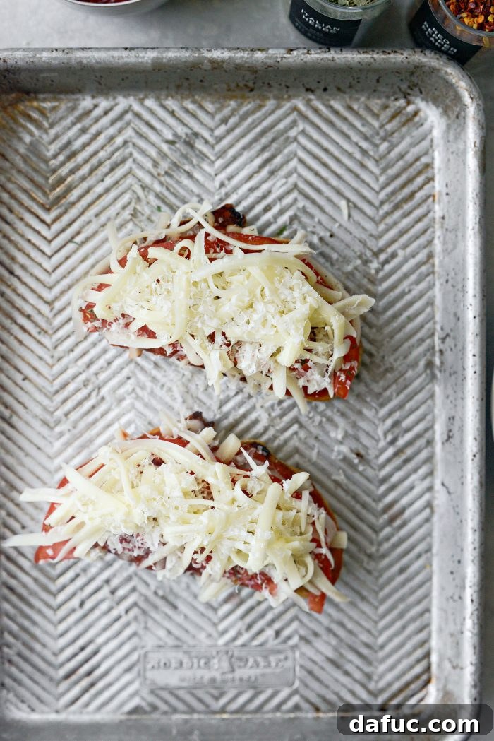 Margherita Toast Pizzas 9 Adding the final layers of mozzarella and Parmesan cheese to pizza toast