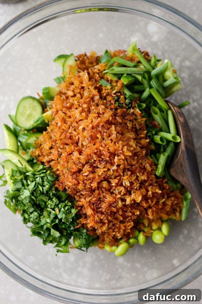 Zesty Crisped Rice Medley 13 Adding crispy rice to the bowl of vegetables and herbs