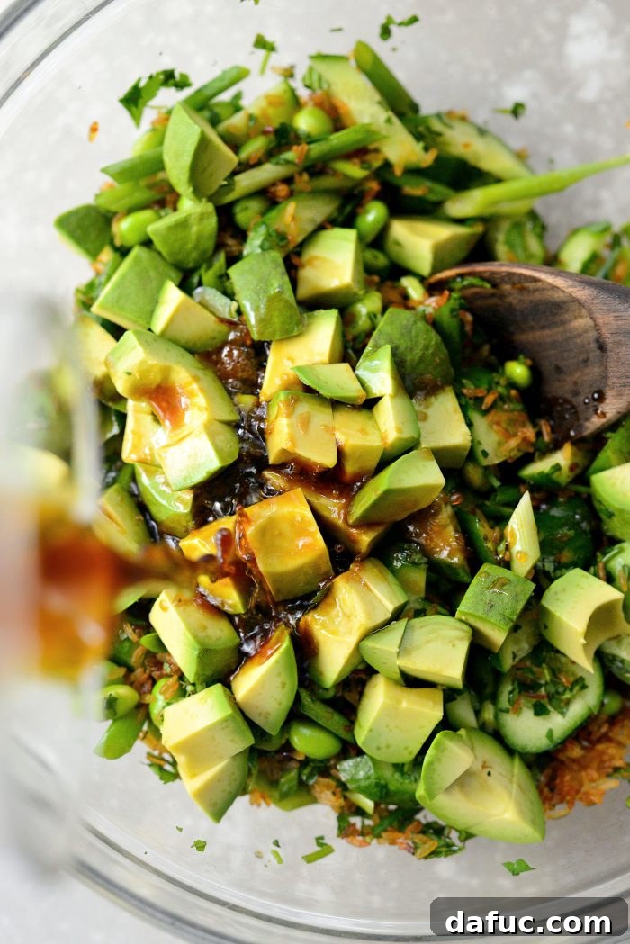 Zesty Crisped Rice Medley 16 Pouring dressing over the assembled Crispy Rice Salad