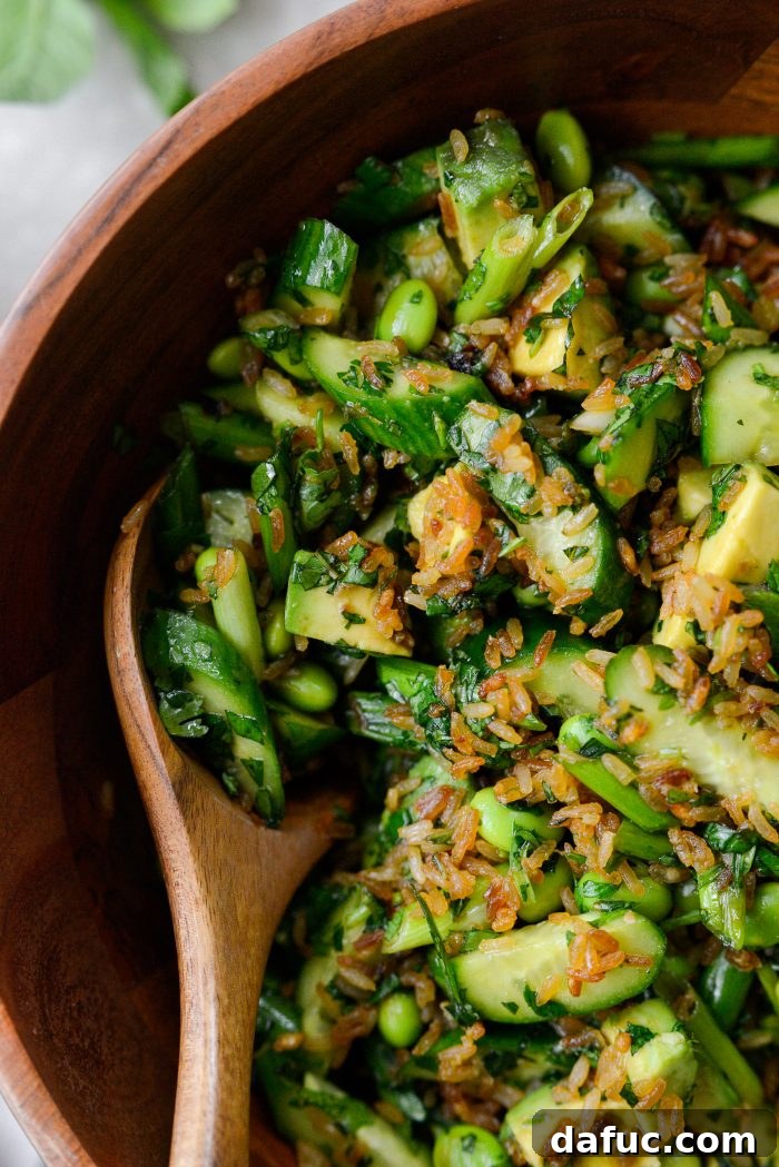 Zesty Crisped Rice Medley 19 Crispy Rice Salad served in a white bowl with fresh herbs