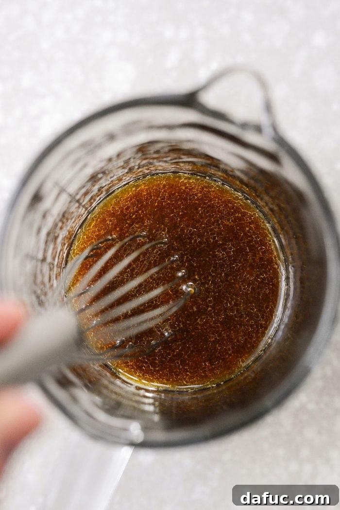 Zesty Crisped Rice Medley 6 Whisking dressing ingredients in a bowl