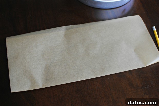 Fold the parchment paper in half along the traced line.