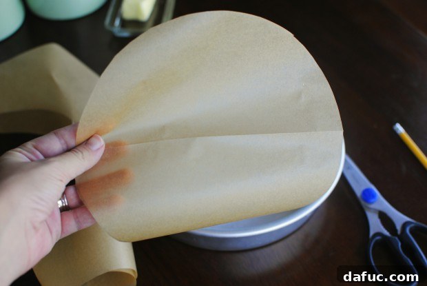 Unfold to reveal your perfectly cut parchment paper circle for the cake pan.