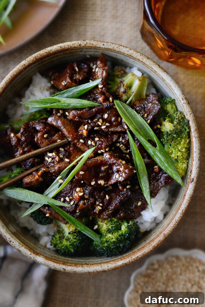 Sheet Pan Steak and Broccoli 2 Delicious Sheet Pan Beef and Broccoli served with rice and garnished with sesame seeds and green onions