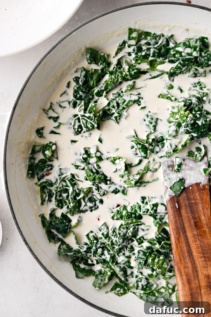 Add chopped kale to the cream sauce and stir until wilted