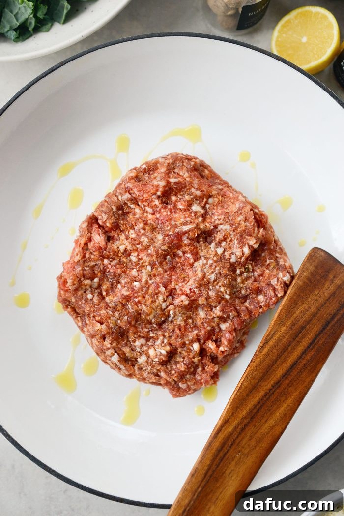 Add olive oil and mild Italian sausage to a large pan