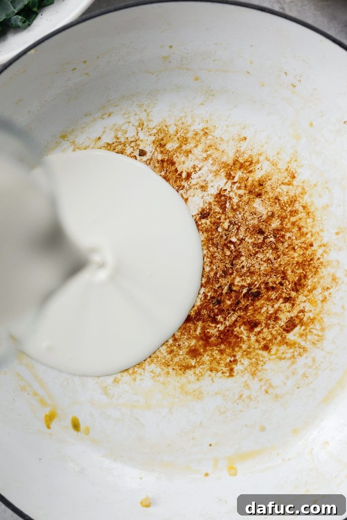 Pour heavy cream into the pan with shallots and garlic