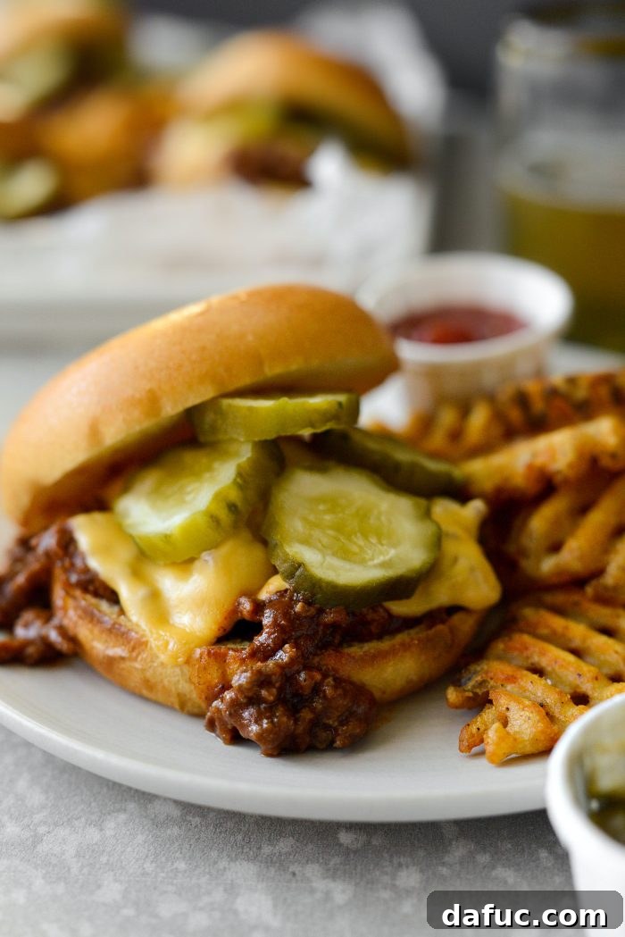 Two sloppy joes on a wooden board