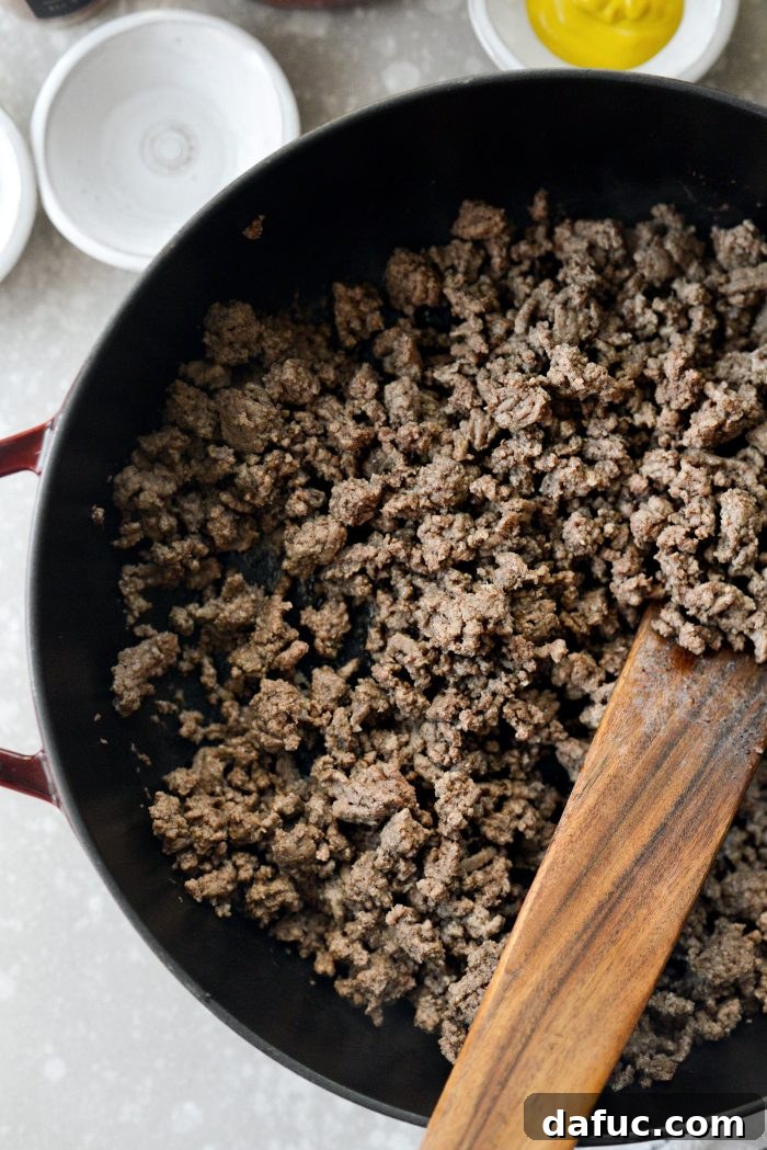 Ground beef being broken up in a skillet