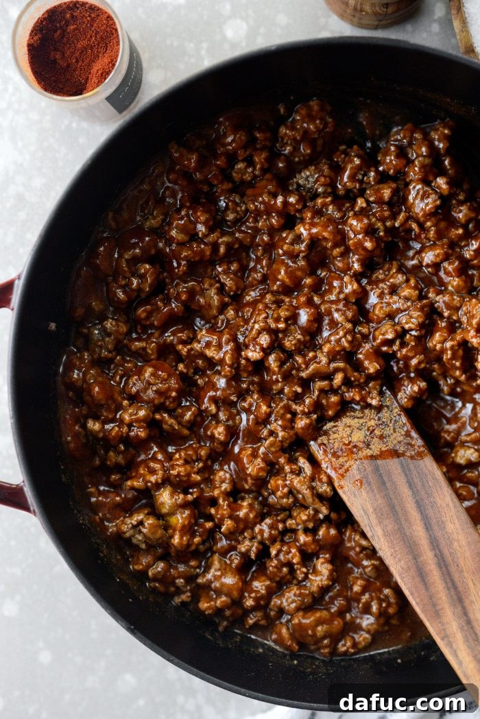 Stirring the sloppy joe sauce in the skillet