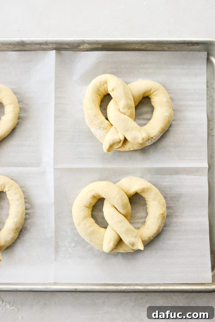 Shaped pretzels on baking sheet