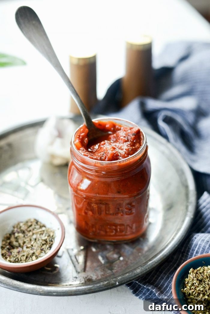 Perfect Homemade Pizza Sauce 2 Jar of robust homemade pizza sauce, glistening with herbs and tomatoes, ready to be used on fresh pizza or stored for later.