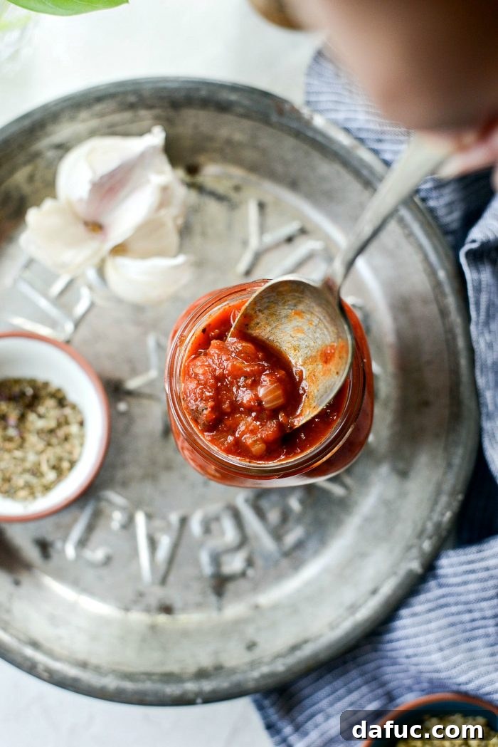 Perfect Homemade Pizza Sauce 3 Two jars of freshly made homemade pizza sauce, showcasing its rich, deep red color and inviting texture.