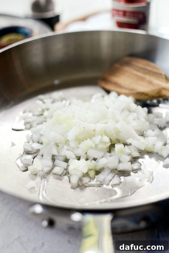 Perfect Homemade Pizza Sauce 5 Finely minced white onions sizzling in olive oil in a skillet, turning translucent.