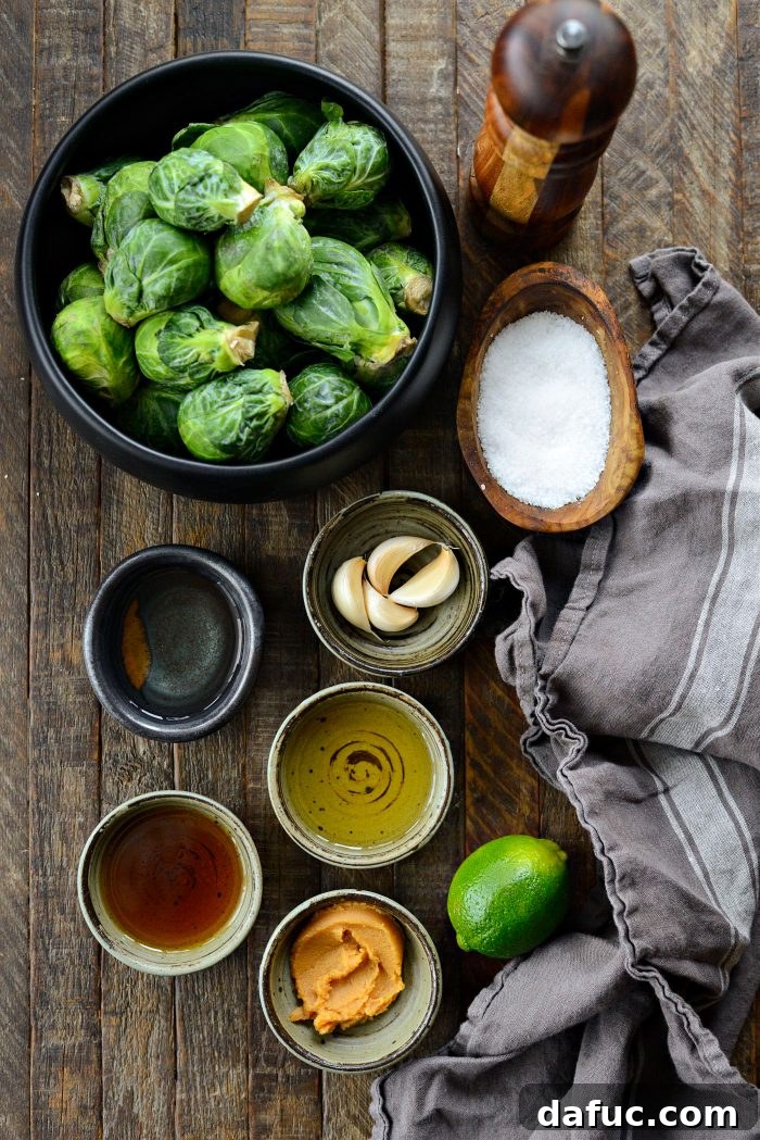 Ingredients for Miso Glazed Roasted Brussels Sprouts laid out on a cutting board