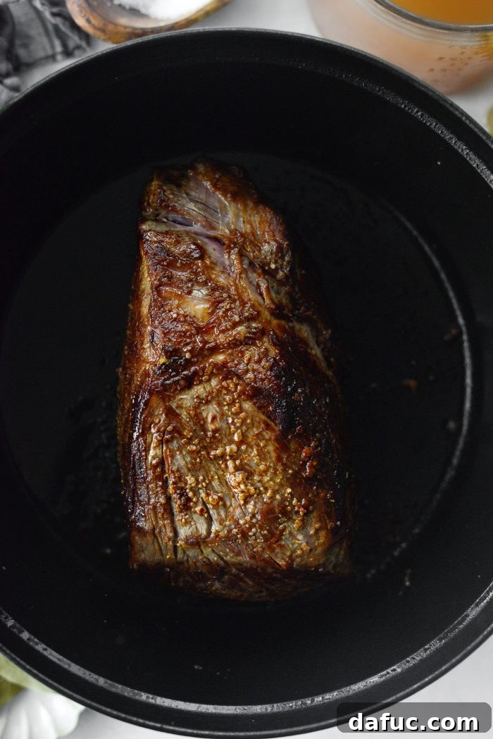 Sweet Onion Braised Beef 7 Searing a beef chuck roast in a hot Dutch oven until golden brown.