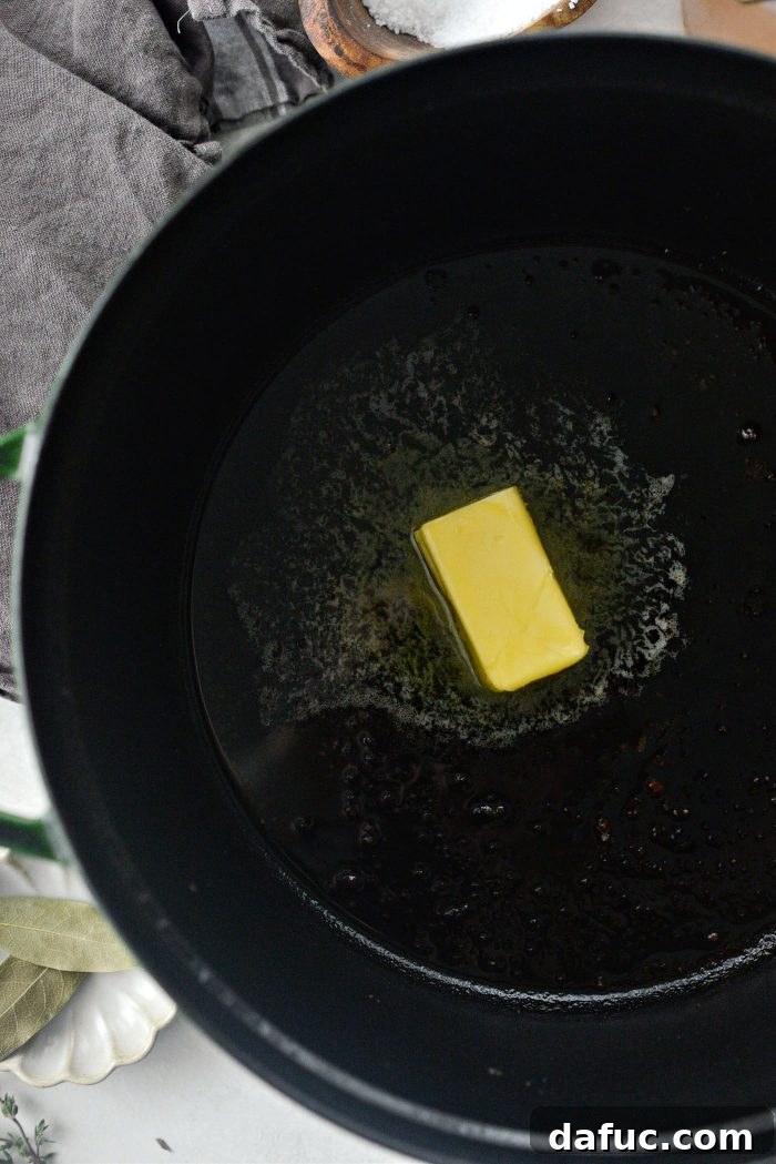 Sweet Onion Braised Beef 9 Adding unsalted butter to the Dutch oven after searing the beef.