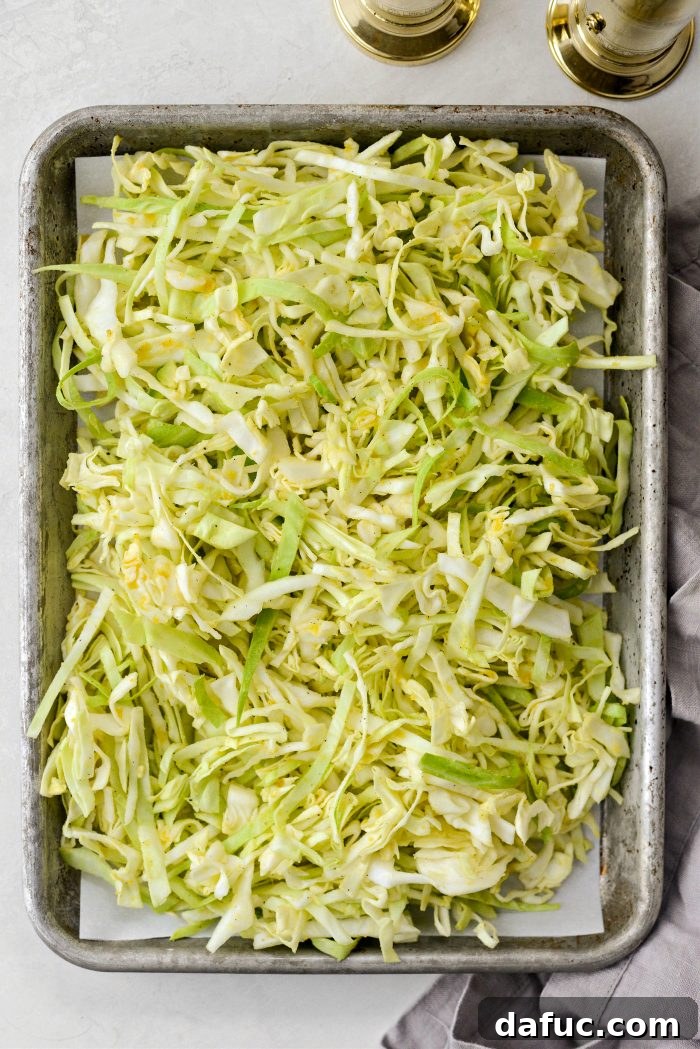 Adding seasoned cabbage to the smaller sheet pan