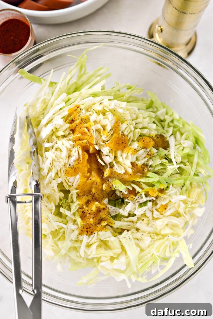 Pouring the bouillon mixture over thinly sliced cabbage
