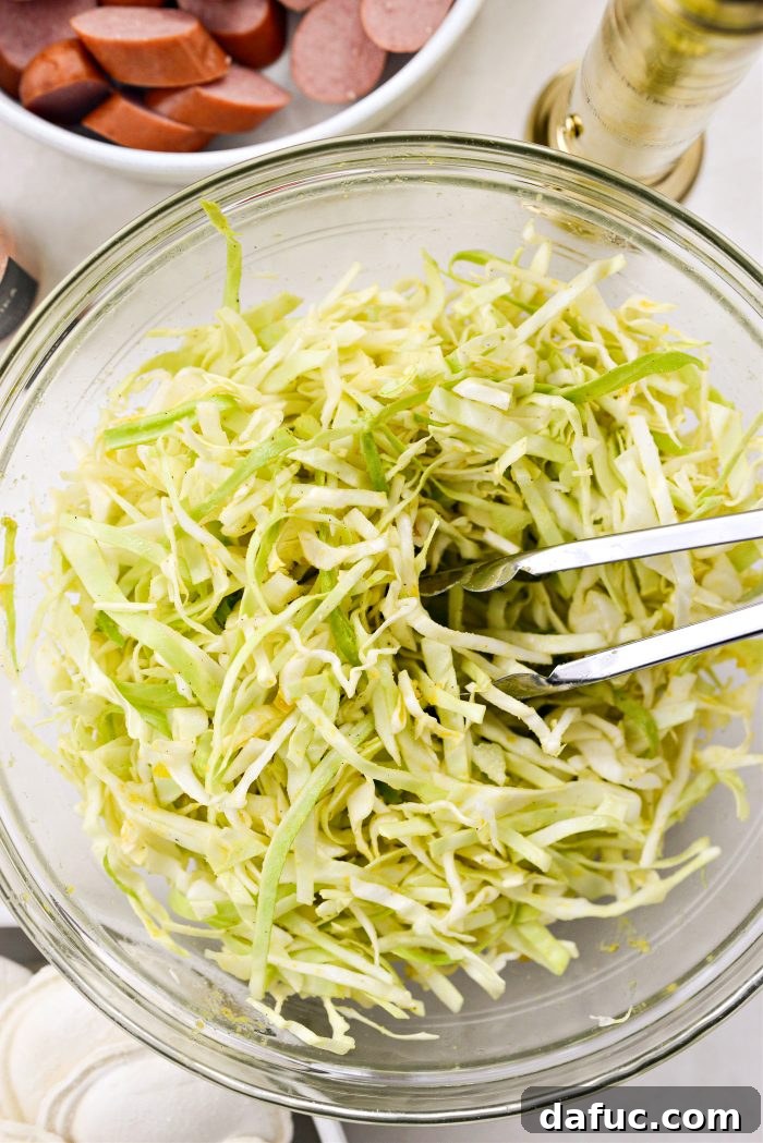 Tossing the seasoned cabbage to combine