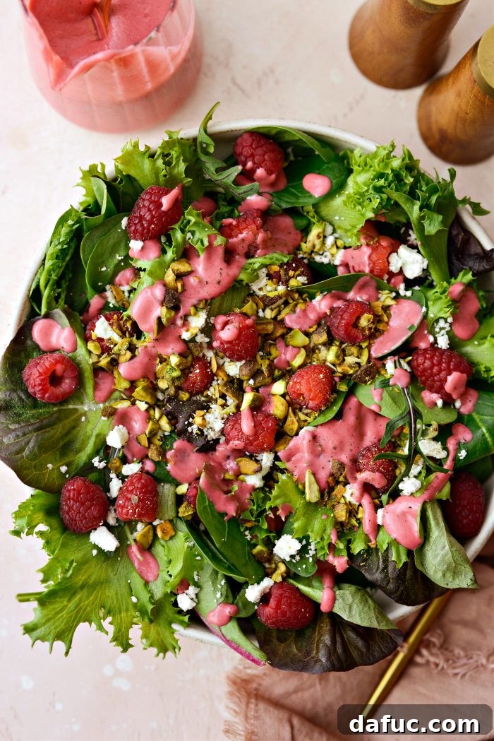 Ruby Red and Green Pistachio Salad 2 Freshly prepared Raspberry Pistachio Salad with a close-up on juicy raspberries, crunchy pistachios, and crumbled feta cheese