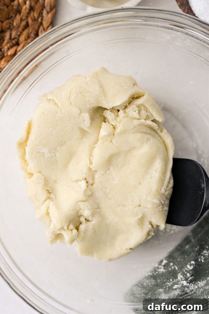 Irish Potato Griddle Cakes 13 Potato dough shaped into a large, round disc on a floured surface, ready to be cut.
