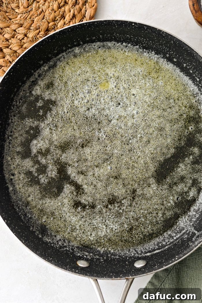 Irish Potato Griddle Cakes 17 Irish Potato Farls frying in a skillet, showcasing their golden-brown edges.