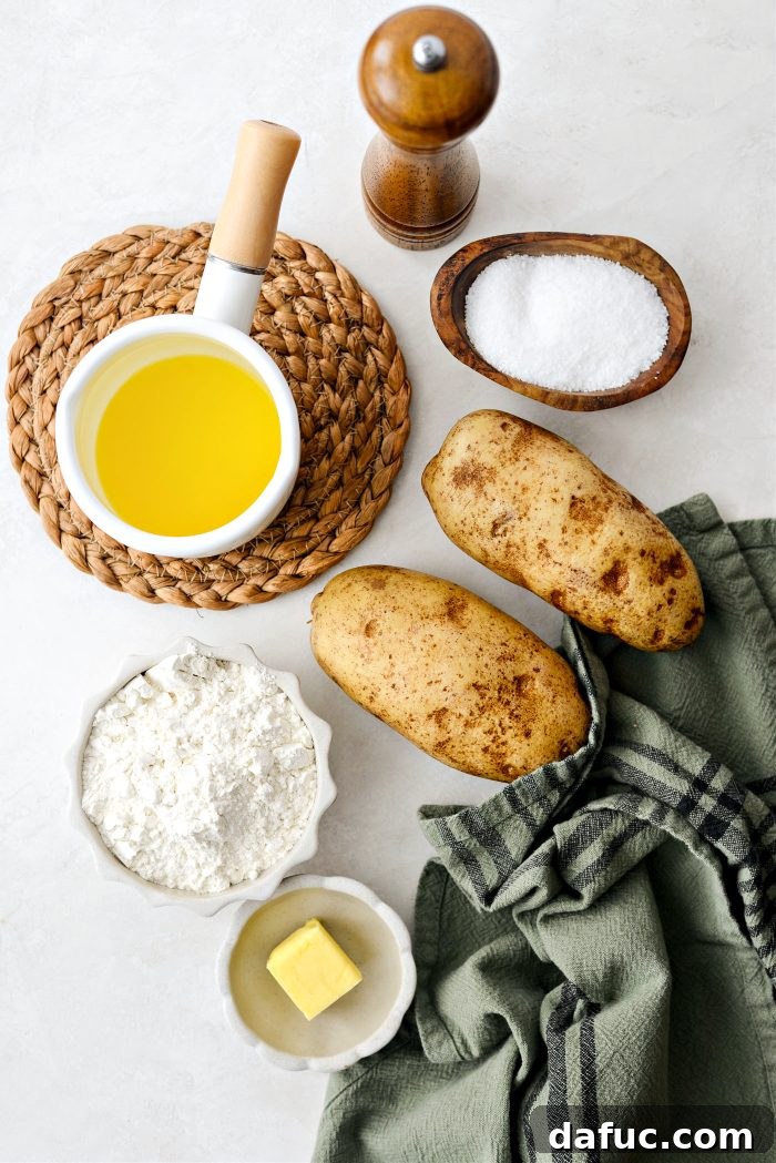 Irish Potato Griddle Cakes 4 Ingredients for Irish Potato Farls laid out on a wooden surface: russet potatoes, flour, butter, salt, and pepper.