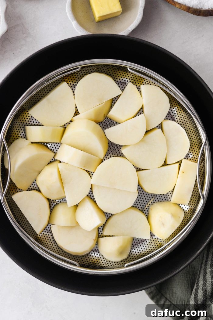 Irish Potato Griddle Cakes 7 Chopped russet potatoes arranged in an even layer inside a steamer basket.