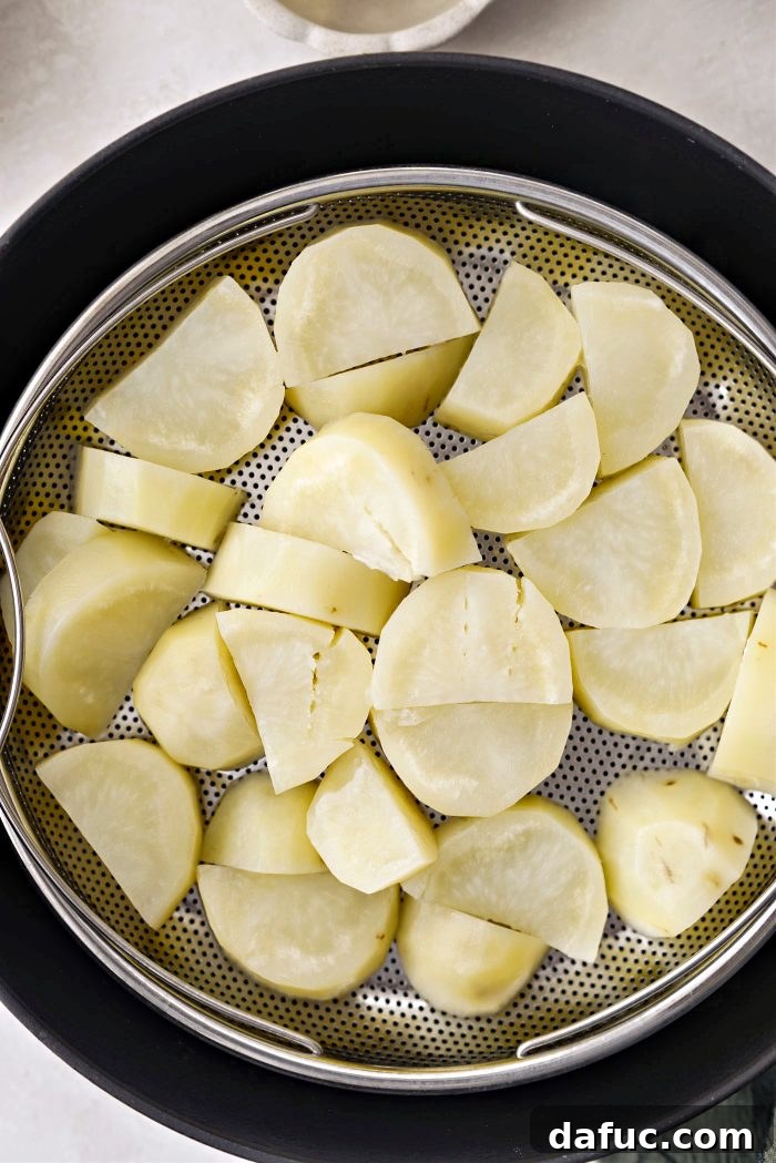 Irish Potato Griddle Cakes 8 Steamed potatoes cooling in a mesh sieve over a bowl to dry out.