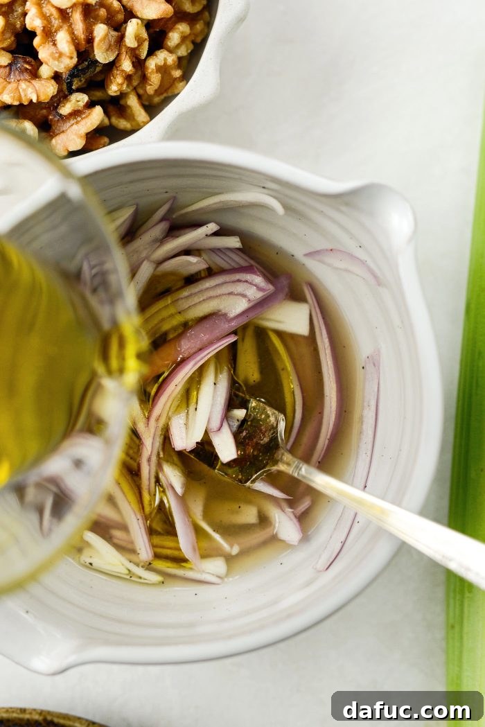 Celery, Date & Parmesan Delight 5 Preparing the bright lemon shallot dressing in a bowl
