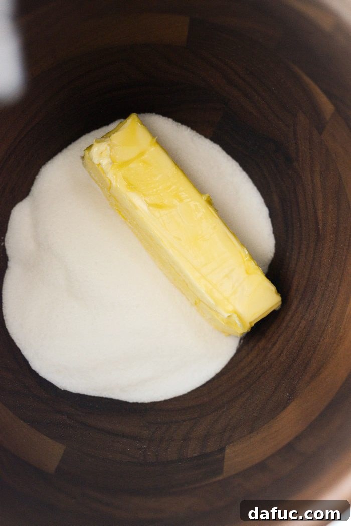 Unsalted butter and sugar in stand mixer bowl