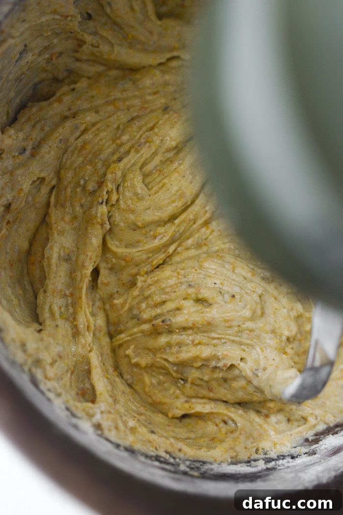 Cake batter being mixed until just combined in a stand mixer bowl