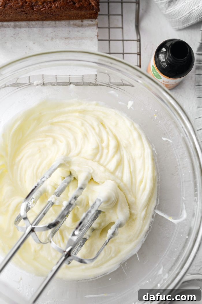Creamy lemon mascarpone frosting in a mixing bowl, ready for spreading