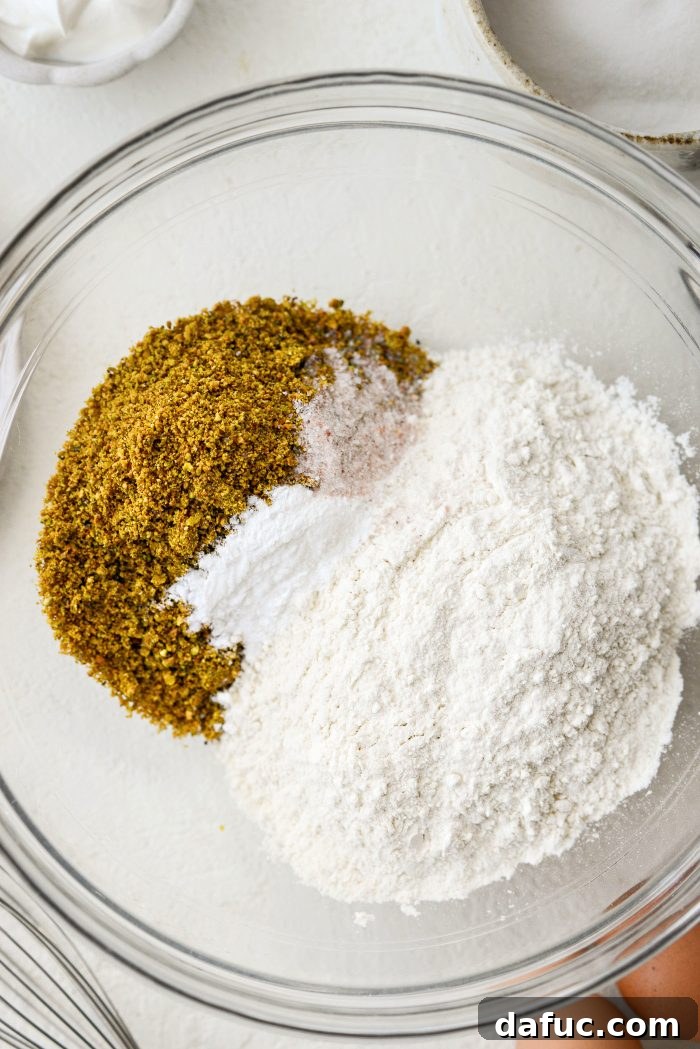 Finely ground lemon pistachios combined with all-purpose flour, baking powder, baking soda, and salt in a mixing bowl