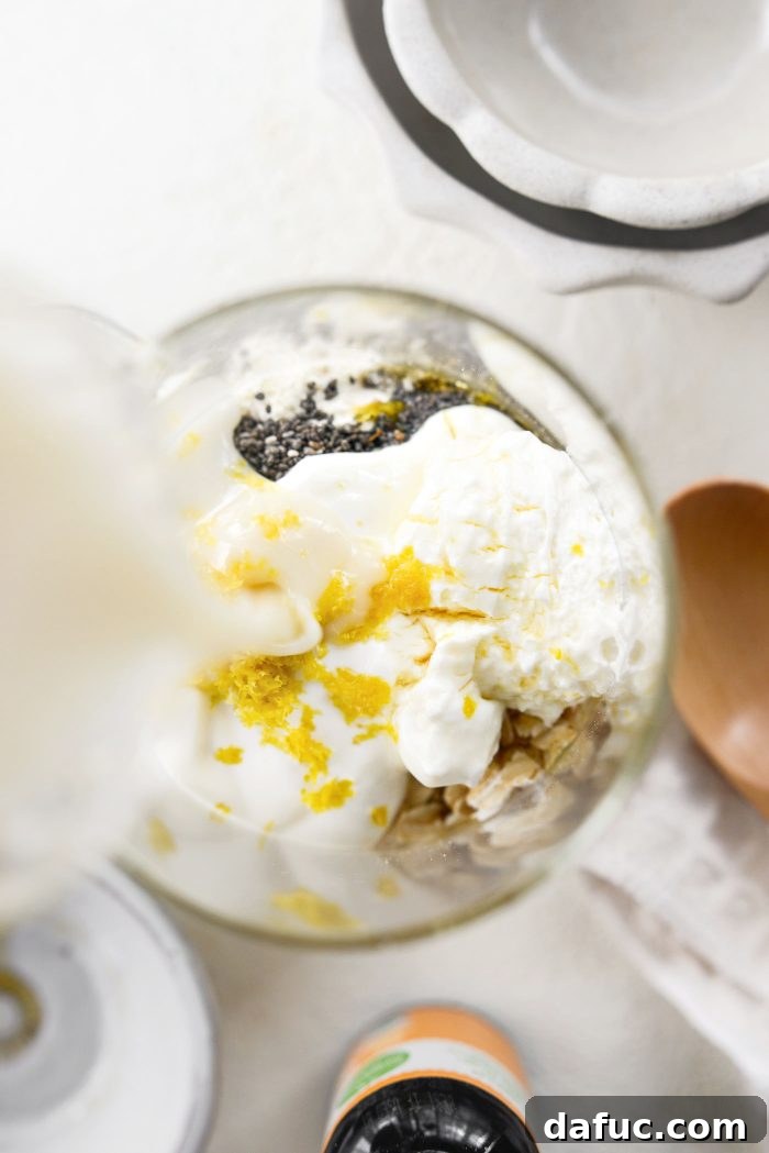 Pouring unsweetened vanilla oat milk into the jar