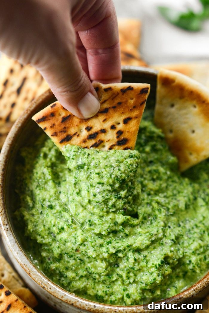Creamy Artichoke Arugula Dip 14 A close-up of the creamy Artichoke Arugula Dip with vibrant green hues.